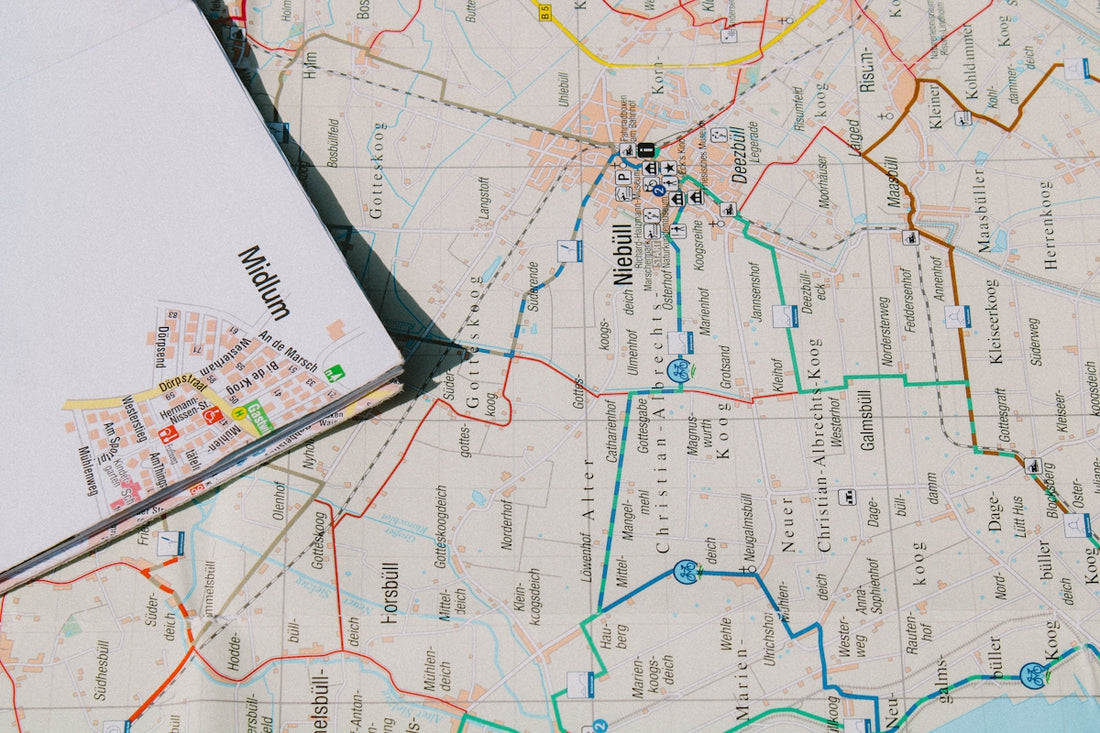 white printer paper on white and yellow map